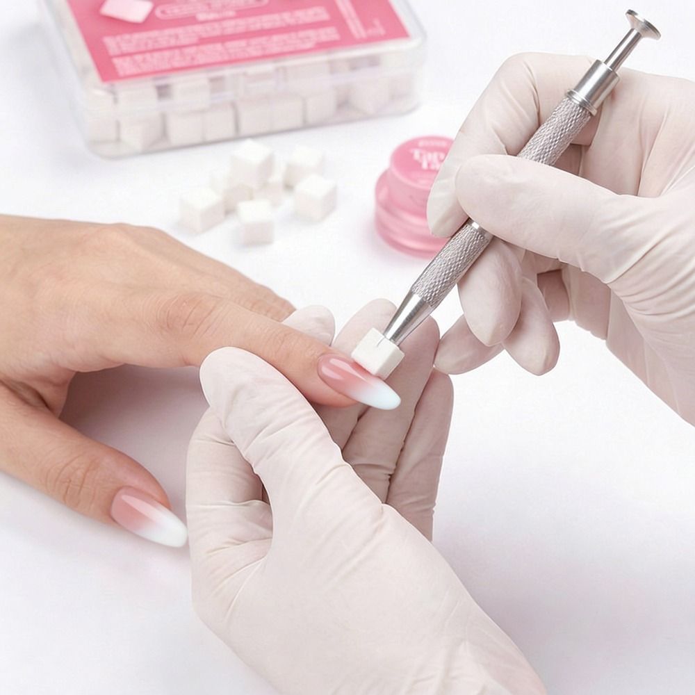 Nahaufnahme einer Maniküre: Hände mit Handschuhen polieren einen modellierten Nagel mit einem speziellen Maniküre-Werkzeug und kleinen Polierwürfeln