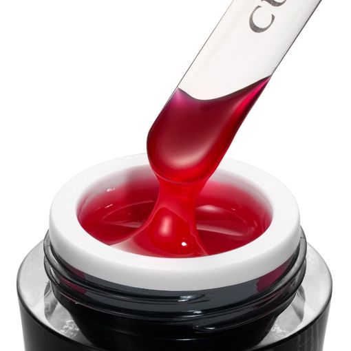 d0216_b Roter Gel-Nagellack wird mit einem Spatel aus einem Glasbehälter entnommen