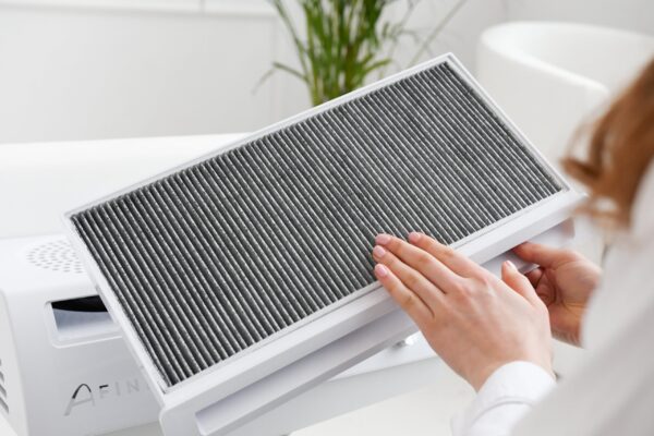 Händedemonstration beim Wechseln eines Filters in einem Luftreiniger