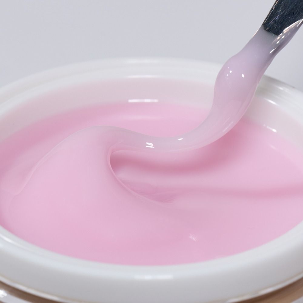 Rosa UV-Aufbaugel im weißen Tiegel, zähflüssig mit Pinsel aufgenommen – Gel für Nagelmodellage und künstliche Fingernägel
