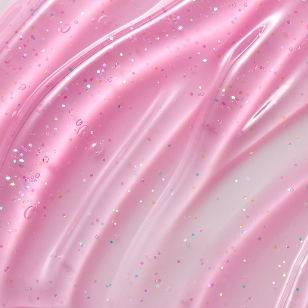Detailaufnahme einer glatten rosa Oberfläche mit funkelndem Glitzer