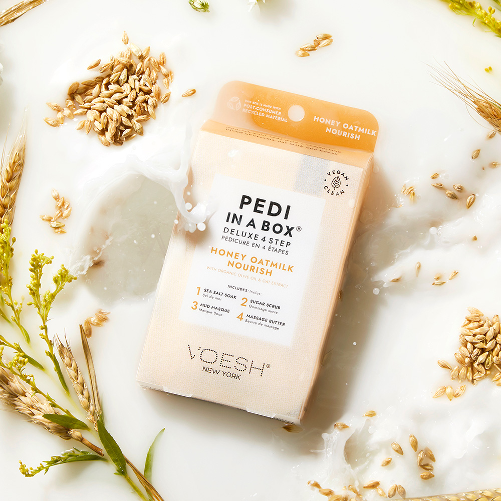 Voesh Pedi in a Box Deluxe 4 Step Honey Oatmilk Nourish, Verpackung des Spa-Pediküre-Sets in milchiger Hafermilch-Optik mit Haferkörnern, pflegende 4-Schritt-Fußpflege
