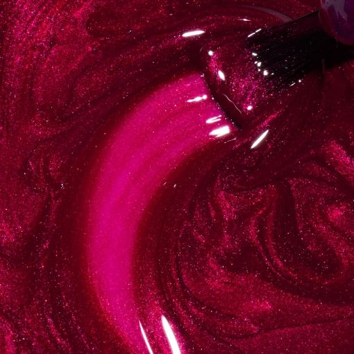 Nahaufnahme eines Nagellackpinsels in schimmerndem pinkem Metallic-Nagellack mit glänzender Textur