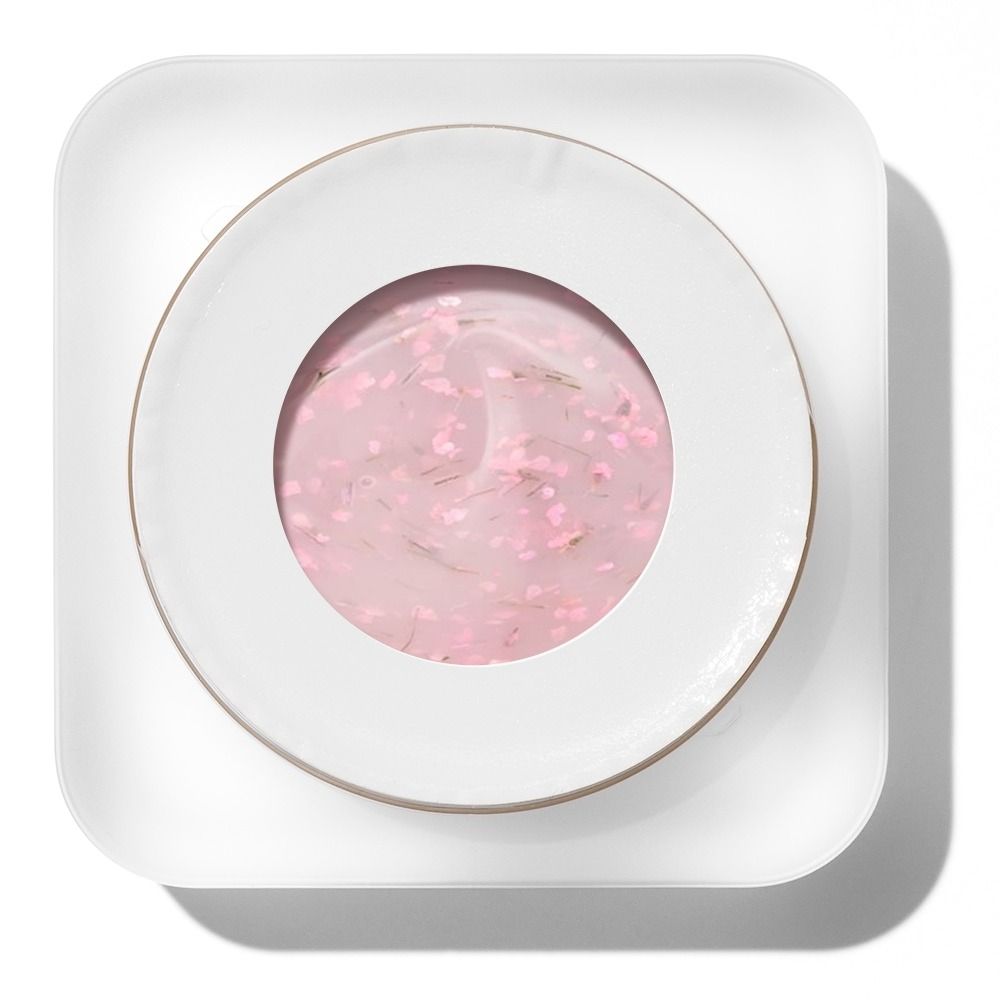 Weiße runde Keramikschale mit rosa Gel, kleinen Blütenpartikeln und dekorativer Oberfläche, von oben fotografiert