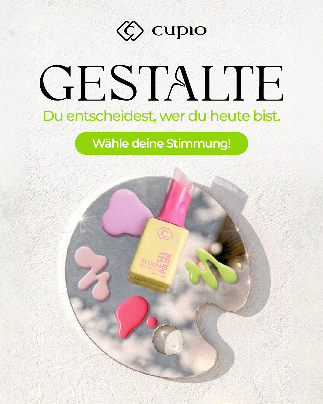 Werbebild für Cupio Bloom Collection Gel Polish: gelber Nagellack auf Künstlerpalette mit bunten Farbtropfen und Slogan „Gestalte – Du entscheidest, wer du heute bist“