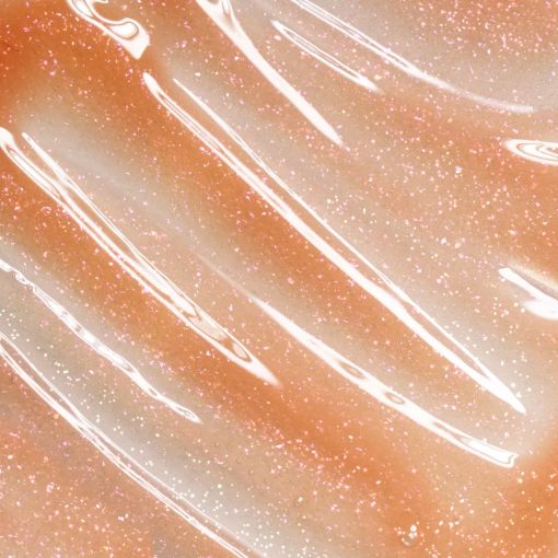 Nahaufnahme einer glitzernden, wellenförmigen Oberfläche in warmen Pfirsich- und Weißtönen