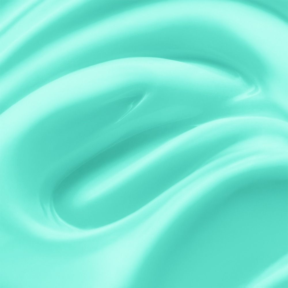 Nahaufnahme einer mintgrünen Creme, die eine glatte und geschmeidige Oberfläche zeigt