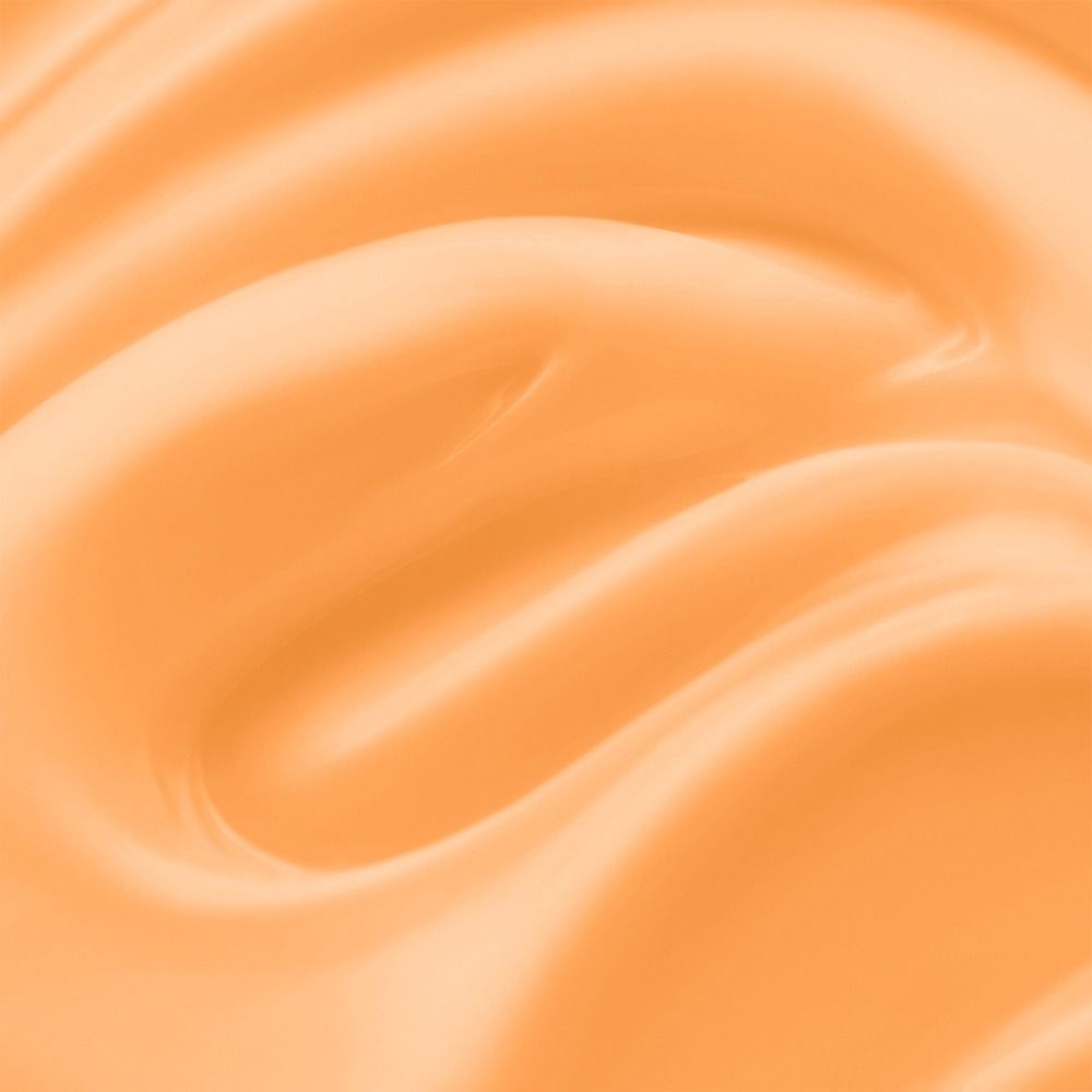 Nahaufnahme einer samtigen, orangefarbene Creme mit glatter Oberfläche