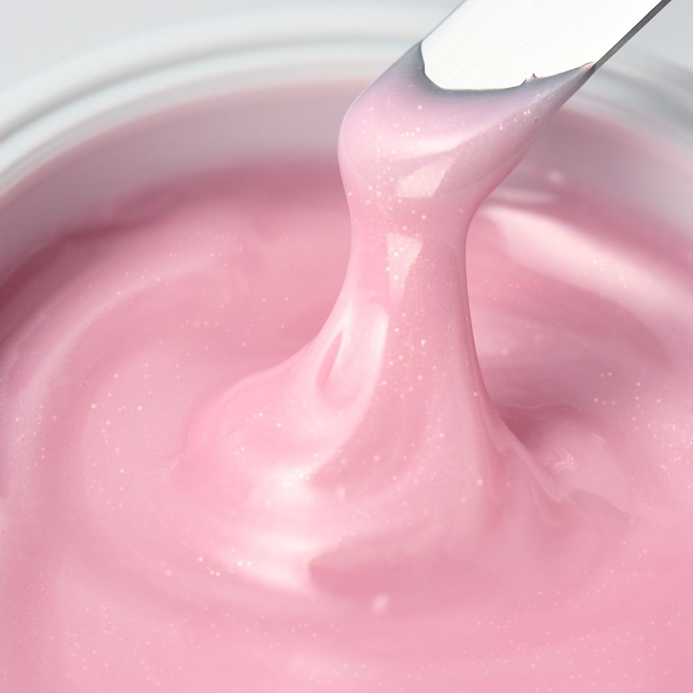 Detailaufnahme einer glitzernden rosa Creme, ideal für Kunst und Bastelarbeiten