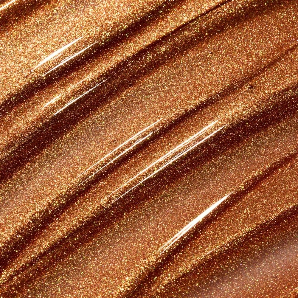 Nahaufnahme von bronzefarbenem, glitzerndem Nagellack auf einer Fläche